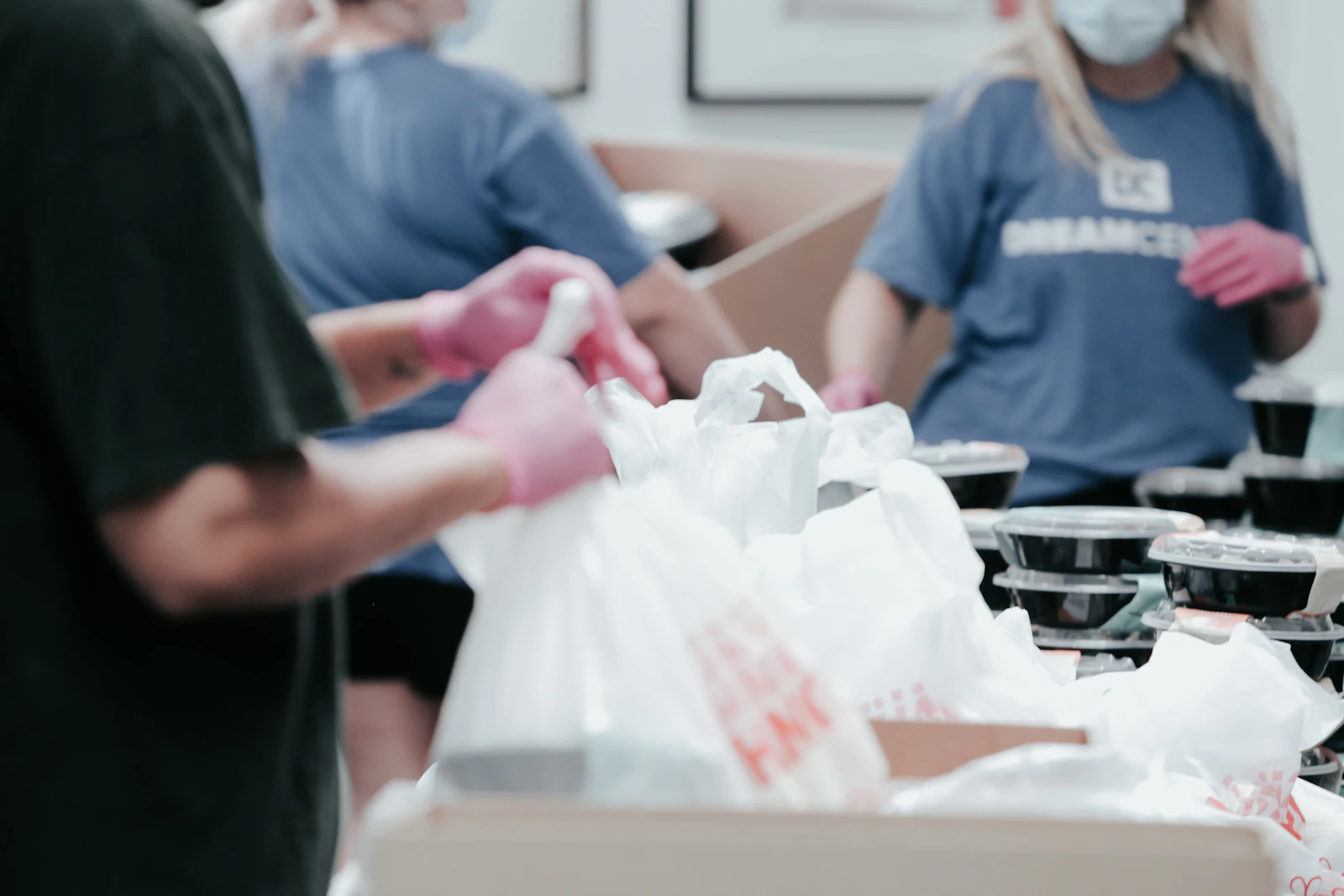 Person delivering a bag of donations to a community charity.